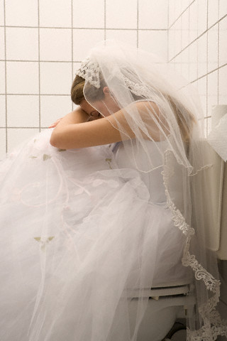 Woman in Wedding Dress in Bathroom